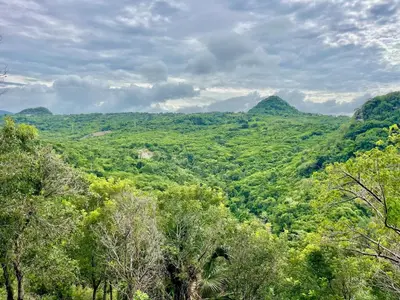 a view of a valley with trees and mountains at Exclusive Mountain Villa with Ocean View near Puerto Plata in Maimón