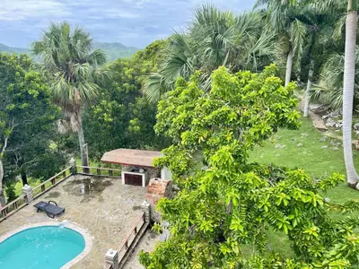 an aerial view of a resort with a swimming pool and trees at Exclusive Mountain Villa with Ocean View near Puerto Plata in Maimón