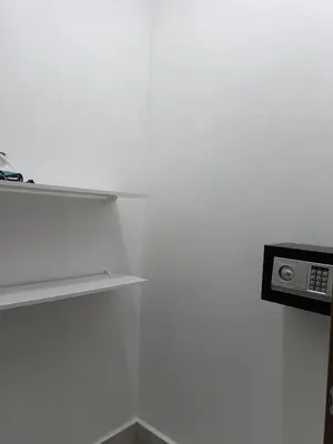 a white room with a shelf and a microwave at Boca del Mar III, apto 707 in Boca Chica