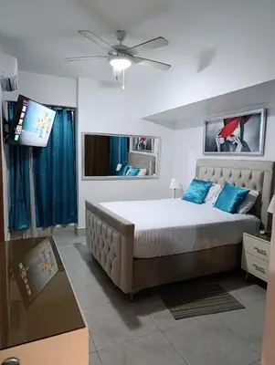 a bedroom with a bed and a flat screen tv at Boca del Mar III, apto 706B in Boca Chica