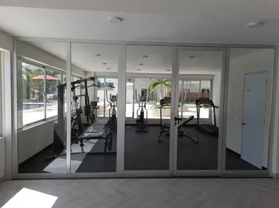 a gym with mirrors and treadmills in a building at Boca del Mar III, apto 706B in Boca Chica