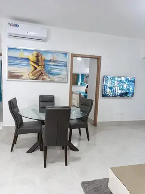 a dining room with a glass table and chairs at Boca del Mar III, apto 706B in Boca Chica