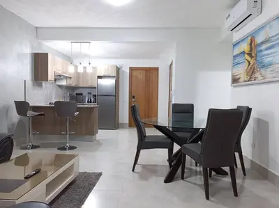 a kitchen and dining room with a table and chairs at Boca del Mar III, apto 706B in Boca Chica
