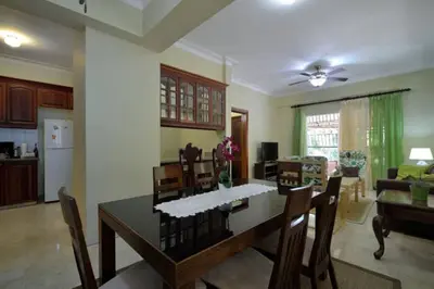 a kitchen and dining room with a table and chairs at Comfortable Apt Laura Virginia in Santo Domingo in Santo Domingo