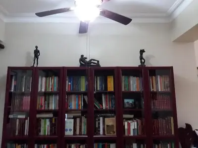 a book shelf with figurines on top of it at Comfortable Apt Laura Virginia in Santo Domingo in Santo Domingo