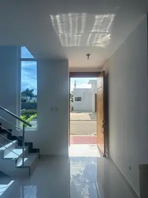 a hallway of a house with a door and stairs at Villa familiar in San Felipe de Puerto Plata