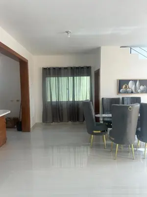 a living room with a dining room table and chairs at Villa familiar in San Felipe de Puerto Plata