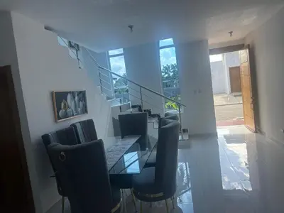 a dining room with a glass table and chairs at Villa familiar in San Felipe de Puerto Plata