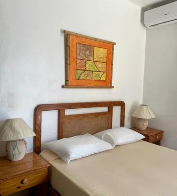 a bedroom with two beds and a stained glass window at Hotel Angel Gabriel in Boca Chica