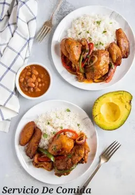 three plates of food on a table with rice and meat at 1st Line view in San Pedro de Macorís