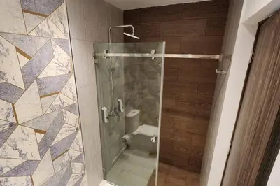 a bathroom with a glass shower with a toilet at 1st Line view in San Pedro de Macorís