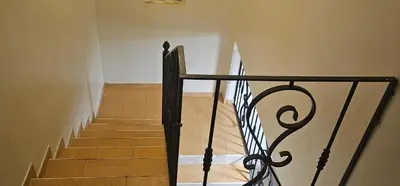 a stairway with a black railing in a building at Paraíso en Repúblico Dominicana in Santiago de los Caballeros
