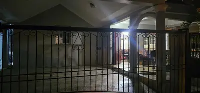 a view of a wrought iron gate in a building at Paraíso en Repúblico Dominicana in Santiago de los Caballeros