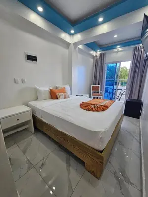 a bedroom with a large bed with a blue ceiling at Hotel Gutz in San Felipe de Puerto Plata
