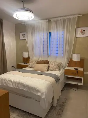 a bedroom with a large bed with a window at Hermoso apto amueblado a 5 minutos de downtown Punta Cana in Punta Cana