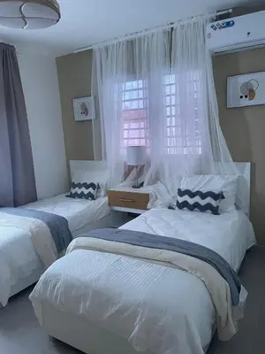 a bedroom with two beds and a window at Hermoso apto amueblado a 5 minutos de downtown Punta Cana in Punta Cana