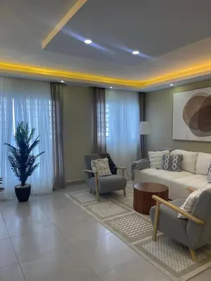 a living room with a white couch and chairs at Hermoso apto amueblado a 5 minutos de downtown Punta Cana in Punta Cana