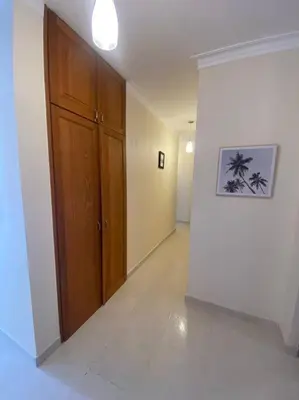 a hallway with a wooden door in a room at Apartment with ocean front view in Juan Dolio