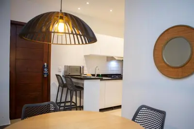 a kitchen with a table and chairs and a mirror at Las Golondrinas Cabarete in Cabarete