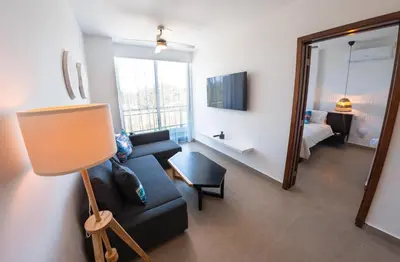 a living room with a couch and a mirror at Las Golondrinas Cabarete in Cabarete