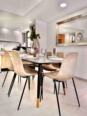 a dining room with a table and chairs at Comfy 2BR City Center Condo in Los Prados