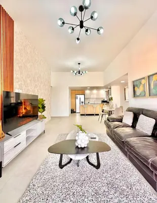 a living room with a couch and a fireplace at Comfy 2BR City Center Condo in Los Prados