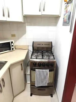 a kitchen with a stove in a small kitchen at Your Tropical HouseRD in La Francia