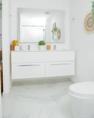 a white bathroom with a sink and a toilet at The Peña family suite in Punta Cana