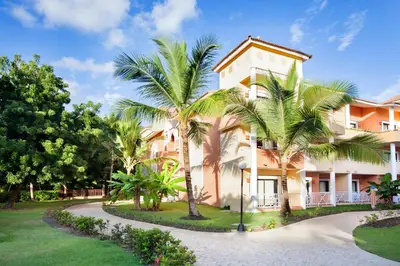 a villa with palm trees and a driveway at Bahia Principe Grand Punta Cana - All Inclusive in Punta Cana