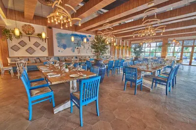 a restaurant with blue chairs and tables in a room at Bahia Principe Luxury Ambar - Adults Only All Inclusive in Punta Cana