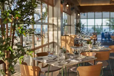 a row of tables with wine glasses in a restaurant at Bahia Principe Luxury Ambar - Adults Only All Inclusive in Punta Cana