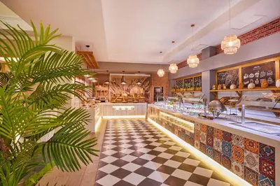 a restaurant with a black and white checkered floor at Bahia Principe Luxury Ambar - Adults Only All Inclusive in Punta Cana