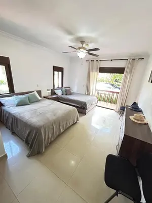 a bedroom with two beds and a ceiling fan at Disfruta momentos inolvidables in Santo Domingo