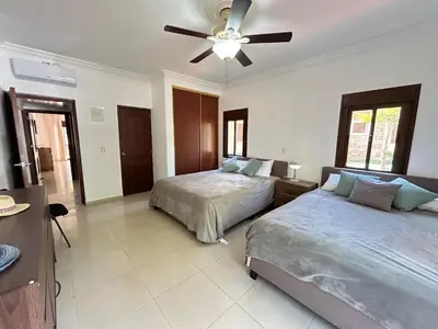 a bedroom with two beds and a ceiling fan at Disfruta momentos inolvidables in Santo Domingo