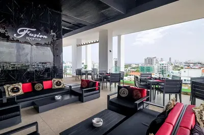a living room with a couch and tables and chairs at Chic Centric 1BR Apt, King Bed in Los Prados