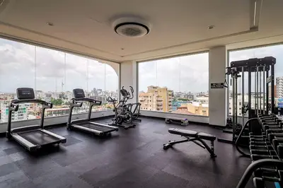 a gym with several tread machines and large windows at Chic Centric 1BR Apt, King Bed in Los Prados