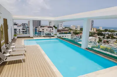 a large swimming pool on the roof of a building at Chic Centric 1BR Apt, King Bed in Los Prados
