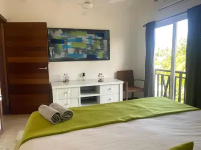 a bedroom with a bed with a dresser and a window at Apartamento centro y playa in Las Terrenas