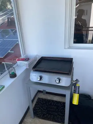 a grill sitting on a table next to a window at Apartamento centro y playa in Las Terrenas