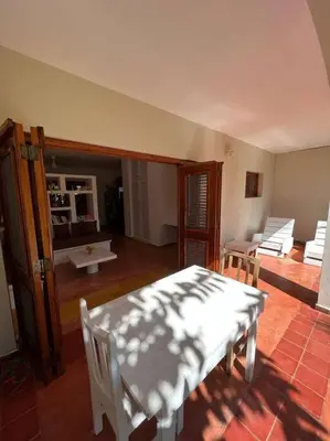 a living room with a table and white chairs at Beach, nature and relaxation in Las Terrenas