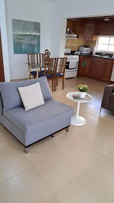 a living room with a couch and a table at guababerry Juan dolio in Los Conucos
