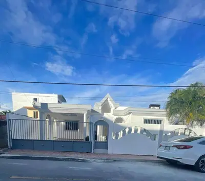 a white house with a car parked in front of it at cabrera villa con vista al mar in Cabrera