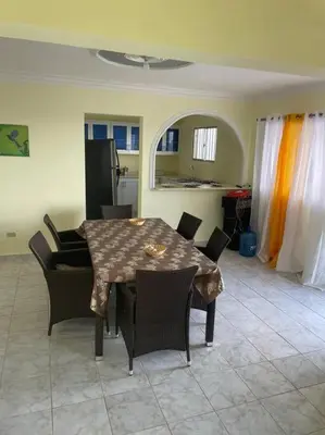 a table and chairs in a room with a kitchen at cabrera villa con vista al mar in Cabrera