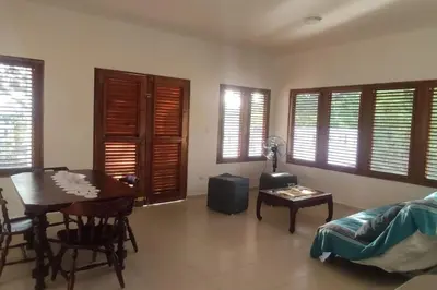 a living room with a table and a dining room at Villa LiMar in Río San Juan
