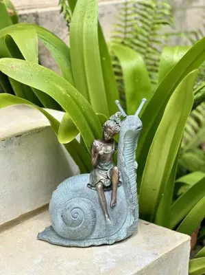 a statue of a woman sitting on a snail at Oceanfront Villa with Staff, Private Pool, BBQ in Las Terrenas