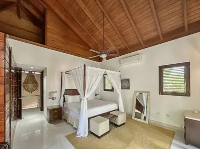 a bedroom with a bed and a ceiling fan at Oceanfront Villa with Staff, Private Pool, BBQ in Las Terrenas