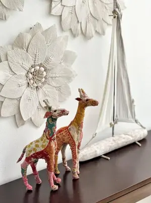 two toy giraffes sitting on a table next to a mirror at Oceanfront Villa with Staff, Private Pool, BBQ in Las Terrenas