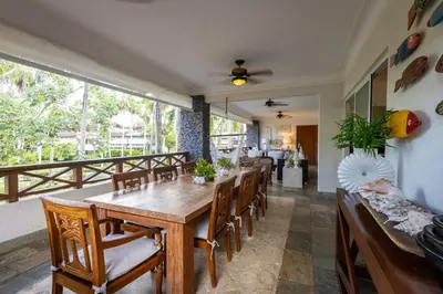 a dining room with a wooden table and chairs at Sunset Cove at Balcones in Las Terrenas