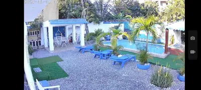 a patio with blue benches and a swimming pool at Villa Luz in Andrés