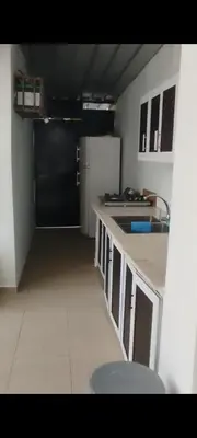 a small kitchen with a refrigerator and a sink at Villa Luz in Andrés